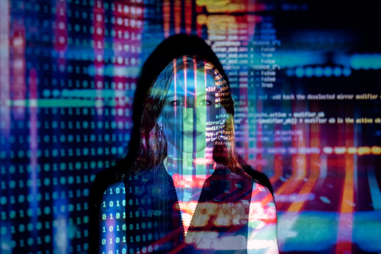 about-02 A woman with digital code projections on her face, representing technology and future concepts.
